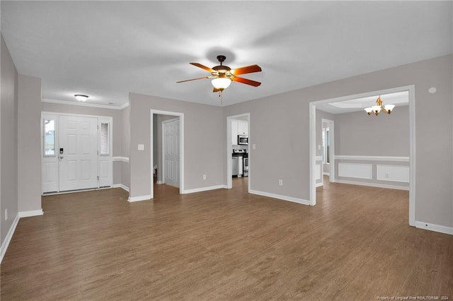 unfurnished living room featuring ceiling fan with notable chandelier and dark hardwood / wood-style floors