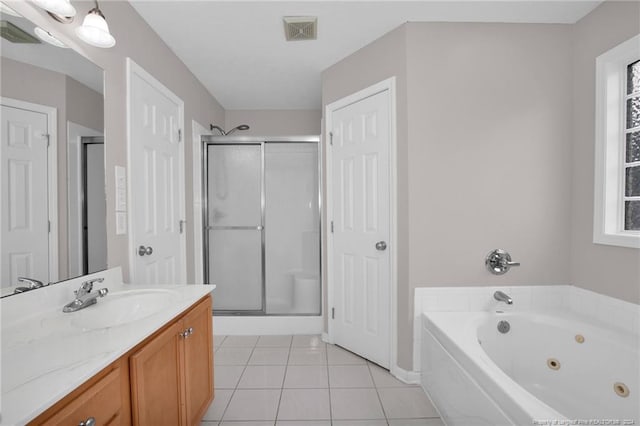 bathroom with tile patterned flooring, vanity, and independent shower and bath