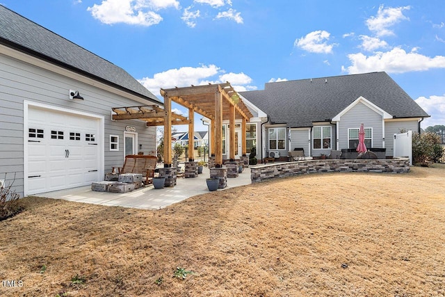 rear view of property featuring a patio area, a garage, and a pergola