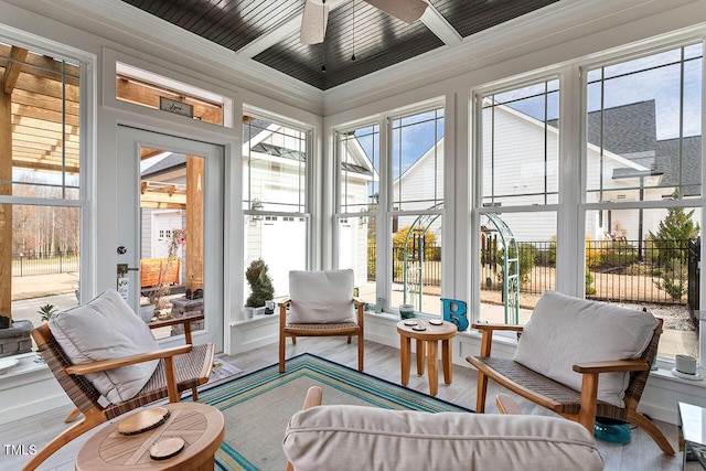 sunroom / solarium featuring plenty of natural light and ceiling fan