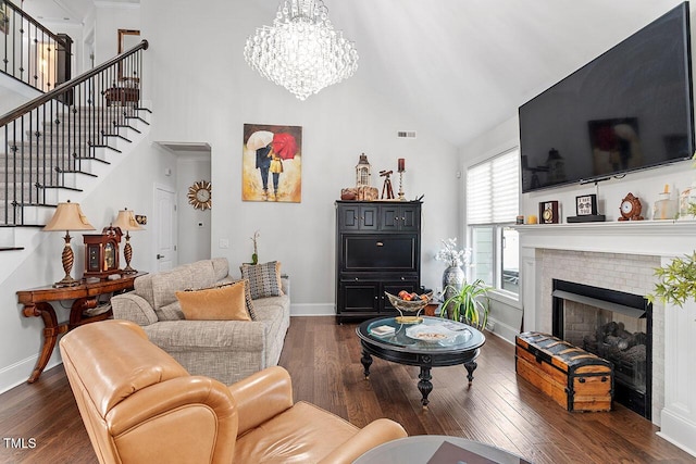 living room with a fireplace, dark hardwood / wood-style floors, and a notable chandelier