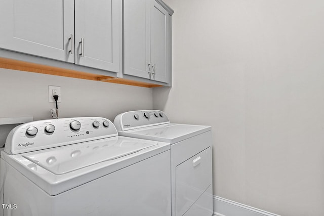 washroom featuring washer and dryer and cabinets