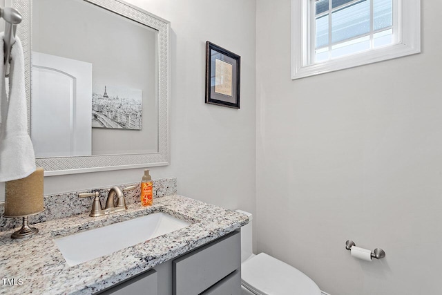 bathroom featuring vanity and toilet