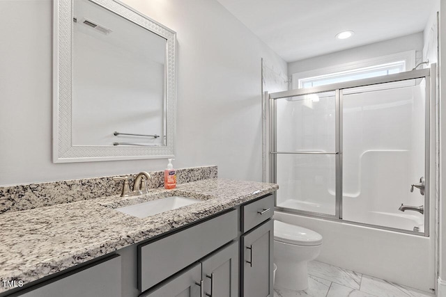 full bathroom with shower / bath combination with glass door, vanity, and toilet