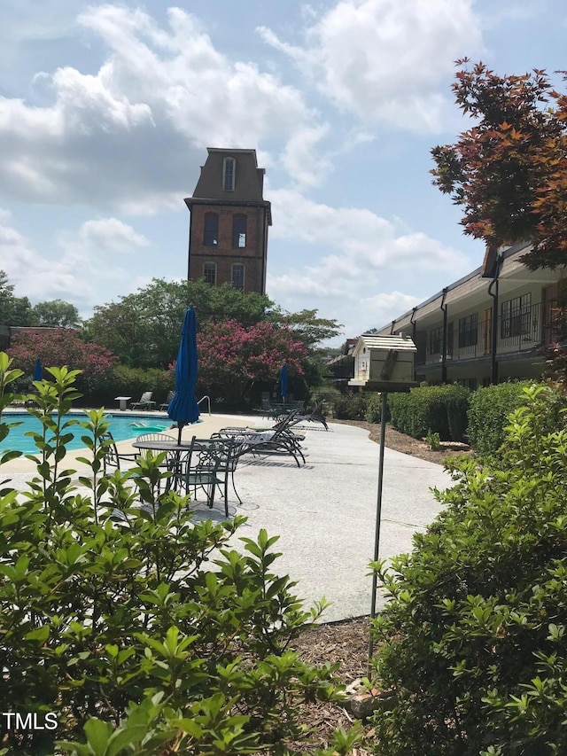 view of community with a patio area and a pool