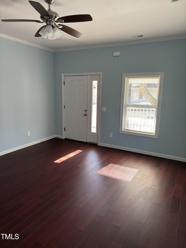 entryway with dark wood-style flooring, visible vents, crown molding, and baseboards