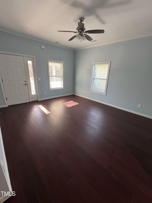 interior space featuring baseboards, ornamental molding, ceiling fan, and dark wood-type flooring