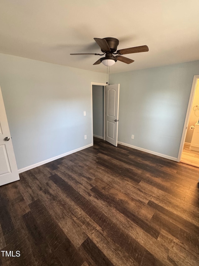 unfurnished bedroom featuring dark wood-style flooring, ceiling fan, and baseboards