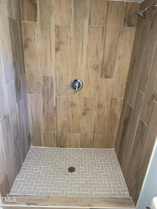 full bath with a tile shower