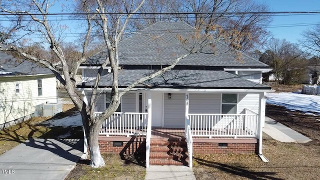 view of front facade featuring crawl space, roof with shingles, and a porch