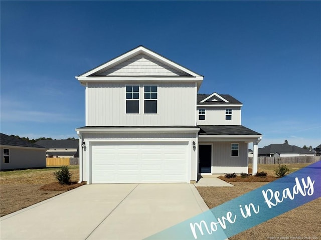 view of front of home featuring driveway, an attached garage, and fence