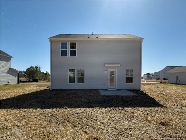 back of property with a patio