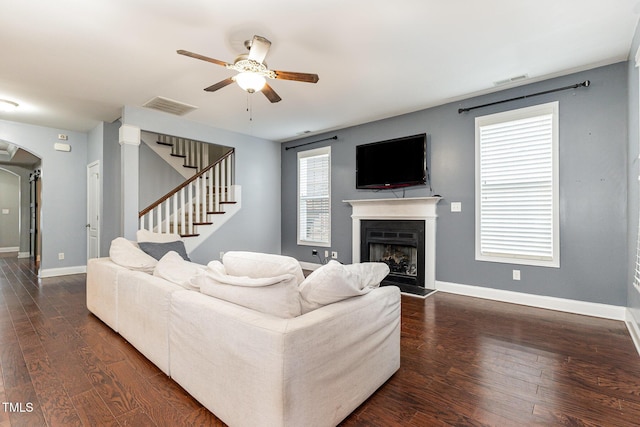 living room featuring dark hardwood / wood-style flooring and ceiling fan