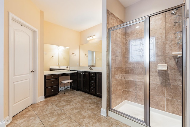 bathroom featuring tile patterned flooring, vanity, and a shower with door