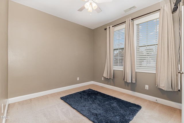 carpeted empty room featuring ceiling fan