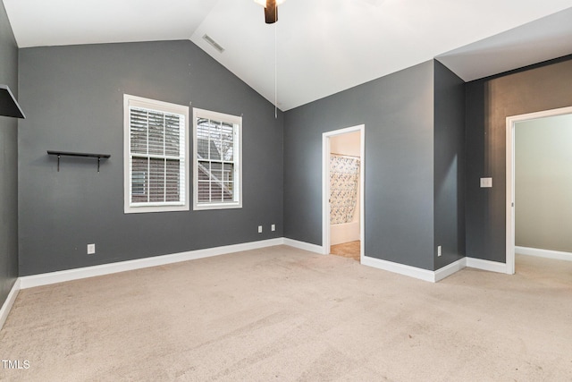 carpeted spare room featuring ceiling fan and lofted ceiling