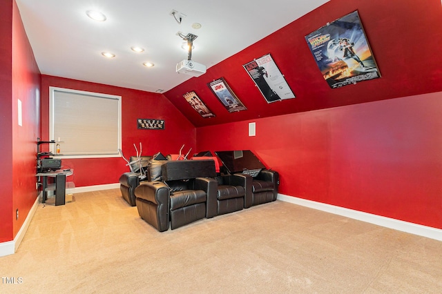 cinema with carpet flooring and lofted ceiling