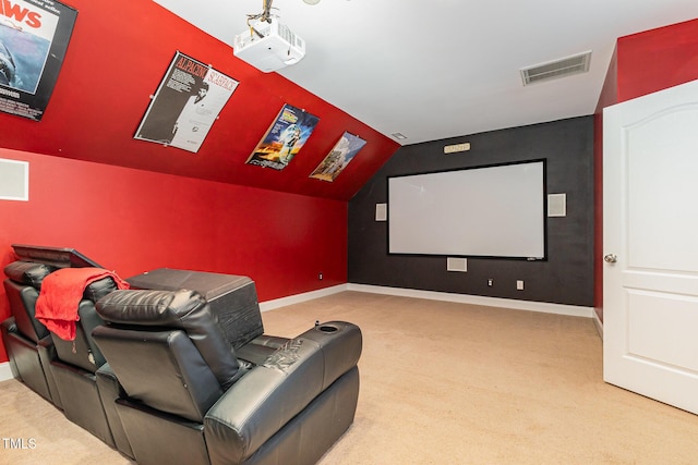 cinema featuring light carpet and vaulted ceiling