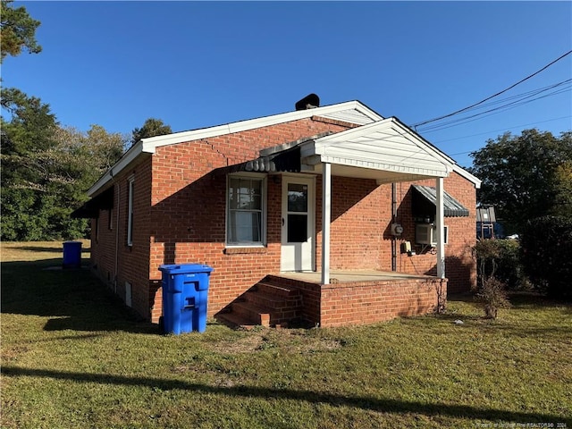 view of side of home with a yard and cooling unit