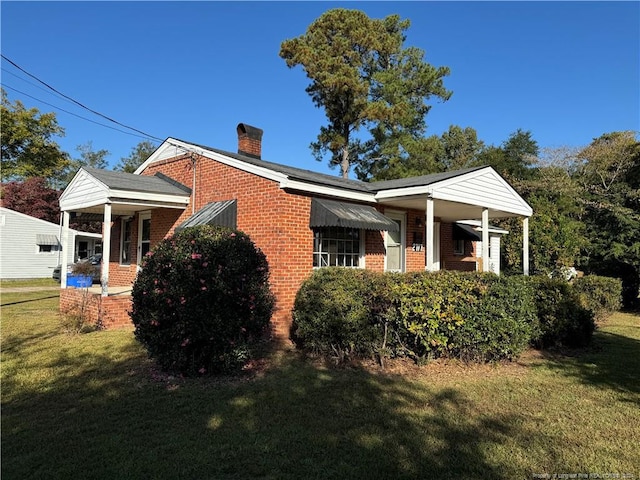 view of side of property with a yard and a porch