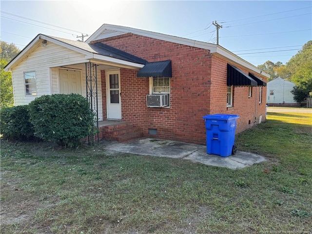 view of front of house with cooling unit and a front lawn