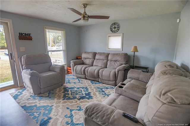 living room featuring a textured ceiling and ceiling fan