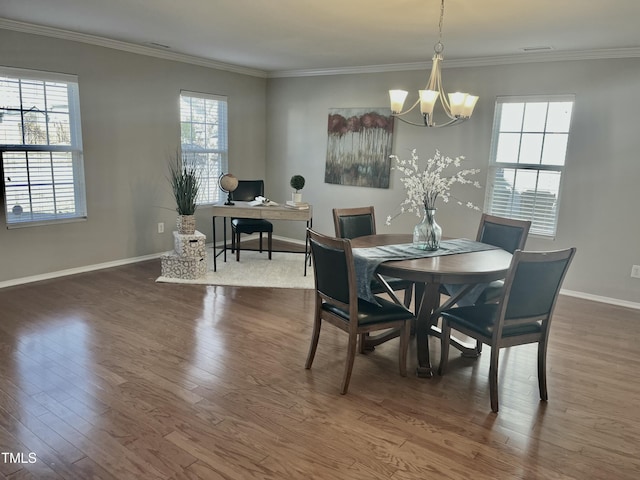 dining room with baseboards, a notable chandelier, dark wood finished floors, and crown molding