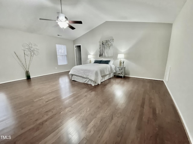 unfurnished bedroom with vaulted ceiling, dark wood-type flooring, a ceiling fan, and baseboards