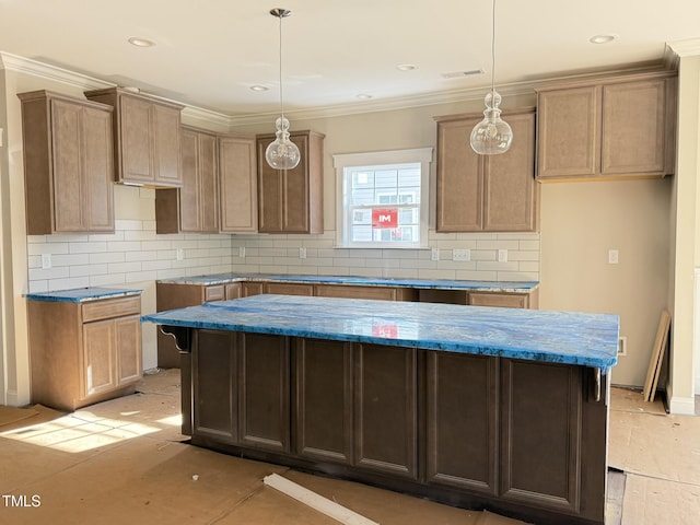 kitchen featuring hanging light fixtures, decorative backsplash, ornamental molding, and a kitchen island