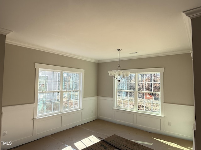 unfurnished dining area with a notable chandelier and crown molding