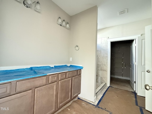 bathroom featuring walk in shower and concrete floors