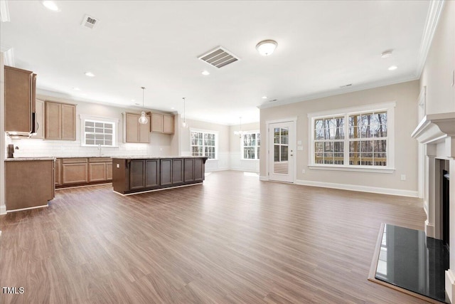 1975 Meadowview Dr, Graham, NC 27253 - kitchen with backsplash, a kitchen island, a fireplace, and visible vents