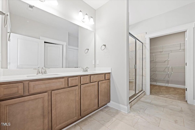 1975 Meadowview Dr, Graham, NC 27253 - bathroom with double vanity, visible vents, a sink, and a shower stall