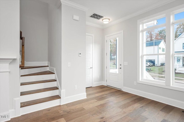 foyer with light hardwood / wood-style floors and ornamental molding