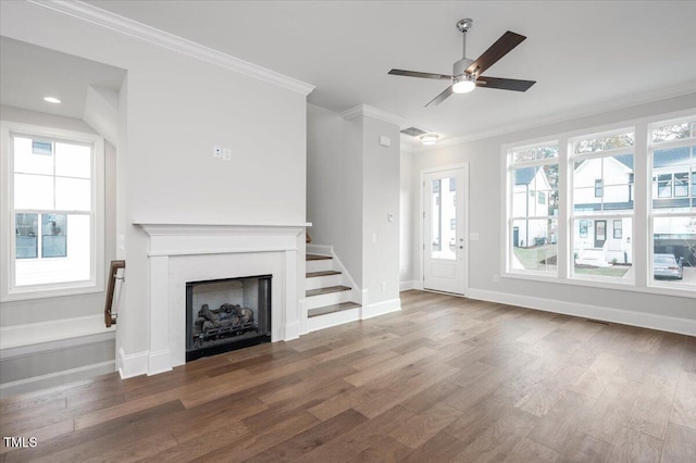 unfurnished living room with crown molding, dark hardwood / wood-style flooring, and ceiling fan