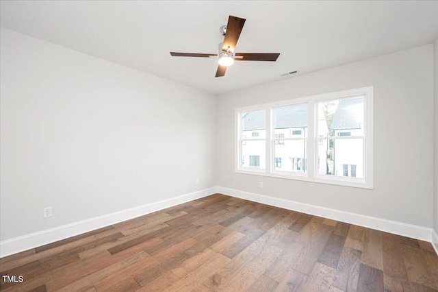 spare room with ceiling fan and hardwood / wood-style floors