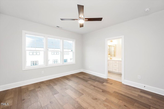 spare room featuring ceiling fan and light wood-type flooring