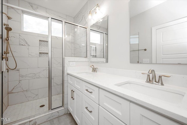 bathroom featuring plenty of natural light, vanity, and a shower with shower door