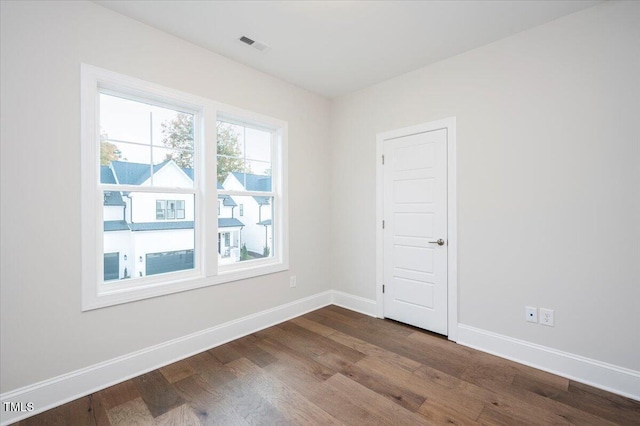 unfurnished room with hardwood / wood-style floors