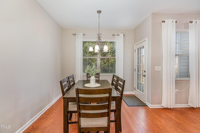 dining room featuring a notable chandelier and hardwood / wood-style flooring