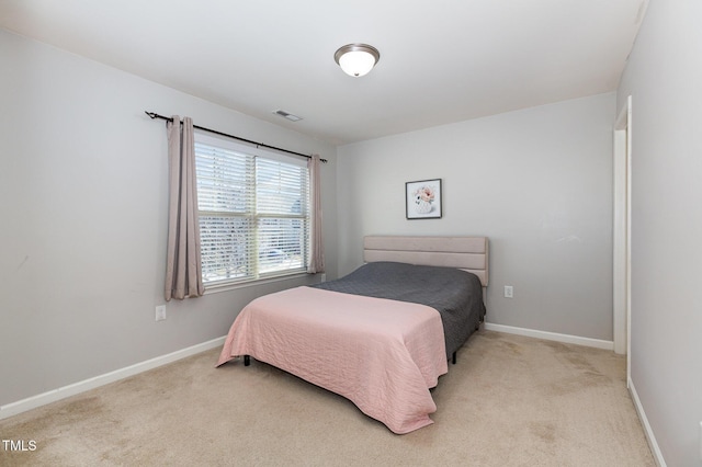 bedroom with light colored carpet