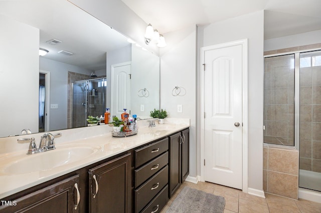 bathroom with tile patterned flooring, vanity, and a shower with shower door