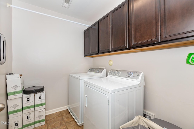 washroom with cabinets and washer and clothes dryer