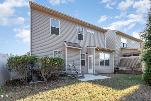 back of property featuring a patio area and a lawn