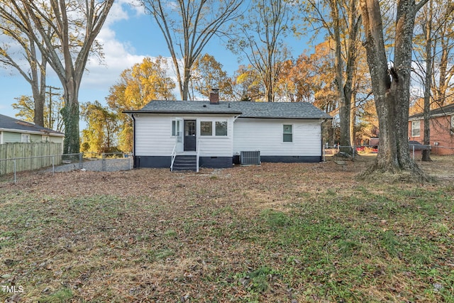 rear view of property with central AC