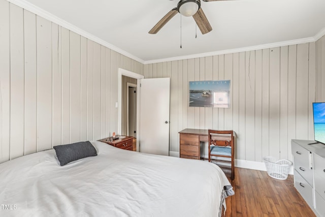 bedroom with hardwood / wood-style floors, ceiling fan, ornamental molding, and wooden walls