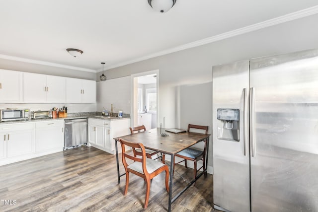 kitchen featuring pendant lighting, white cabinets, crown molding, dark hardwood / wood-style flooring, and stainless steel appliances