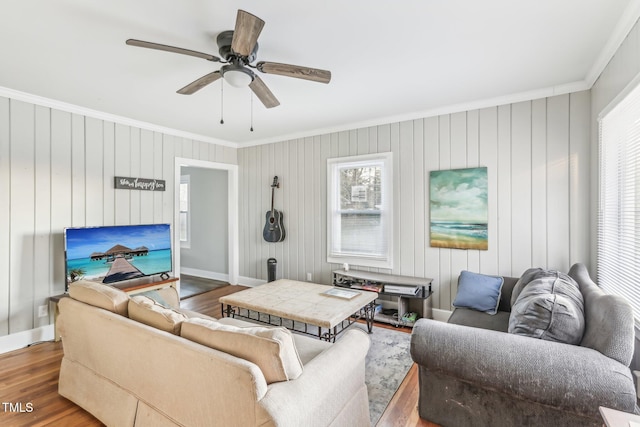 living room featuring hardwood / wood-style floors, plenty of natural light, and crown molding