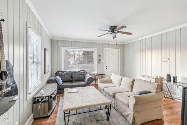 living room with ceiling fan, light hardwood / wood-style floors, and ornamental molding