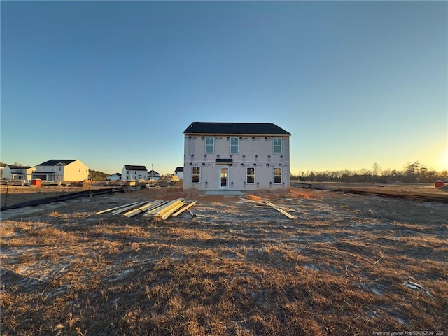 view of back house at dusk